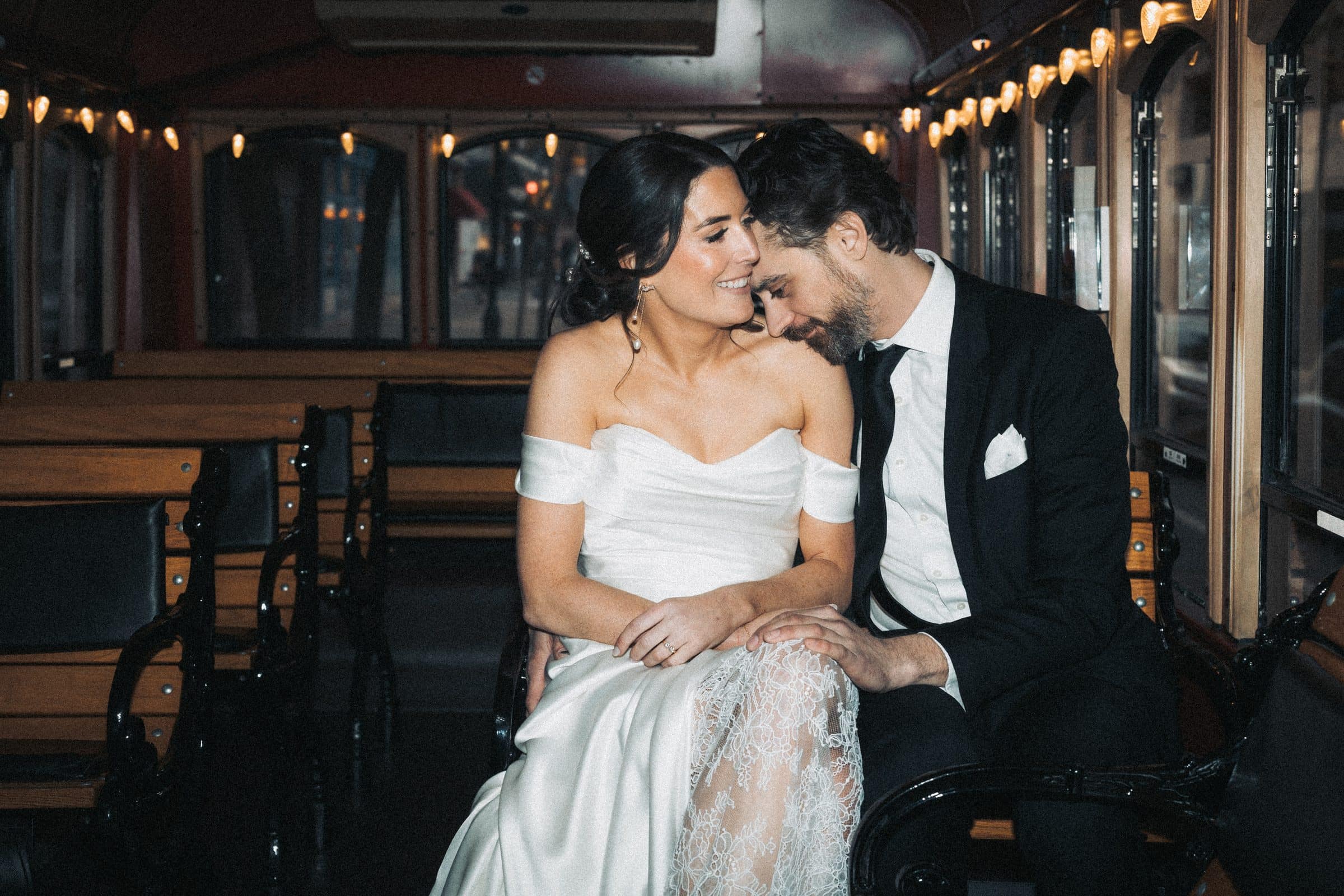 A couple sharing a candid, intimate moment at their wedding