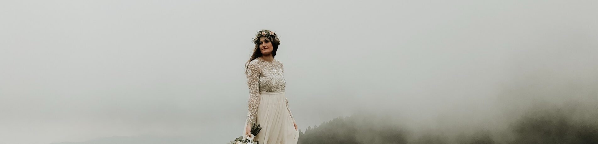 bride-posing-on-a-foggy-mountain