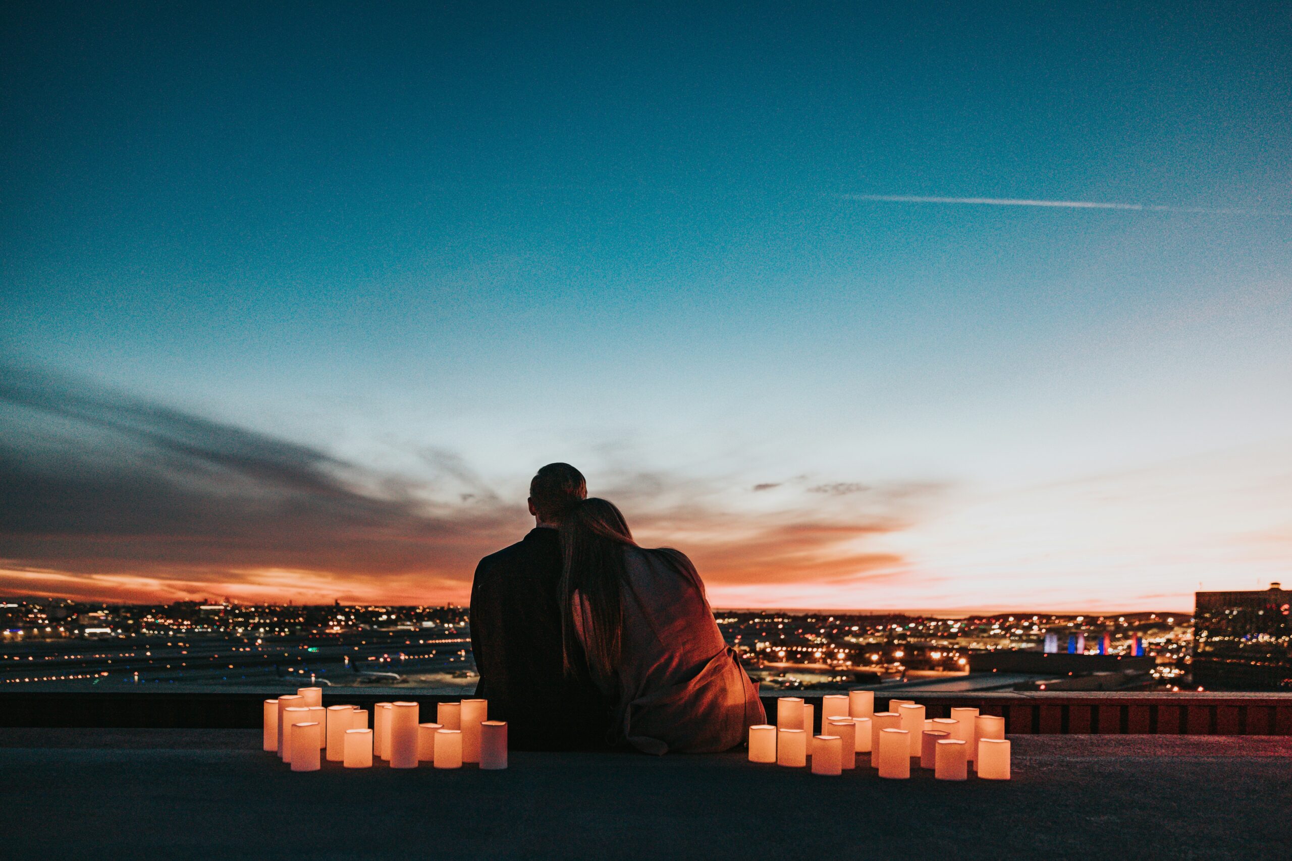 couple looking at a city skyline surrounded by lanterns