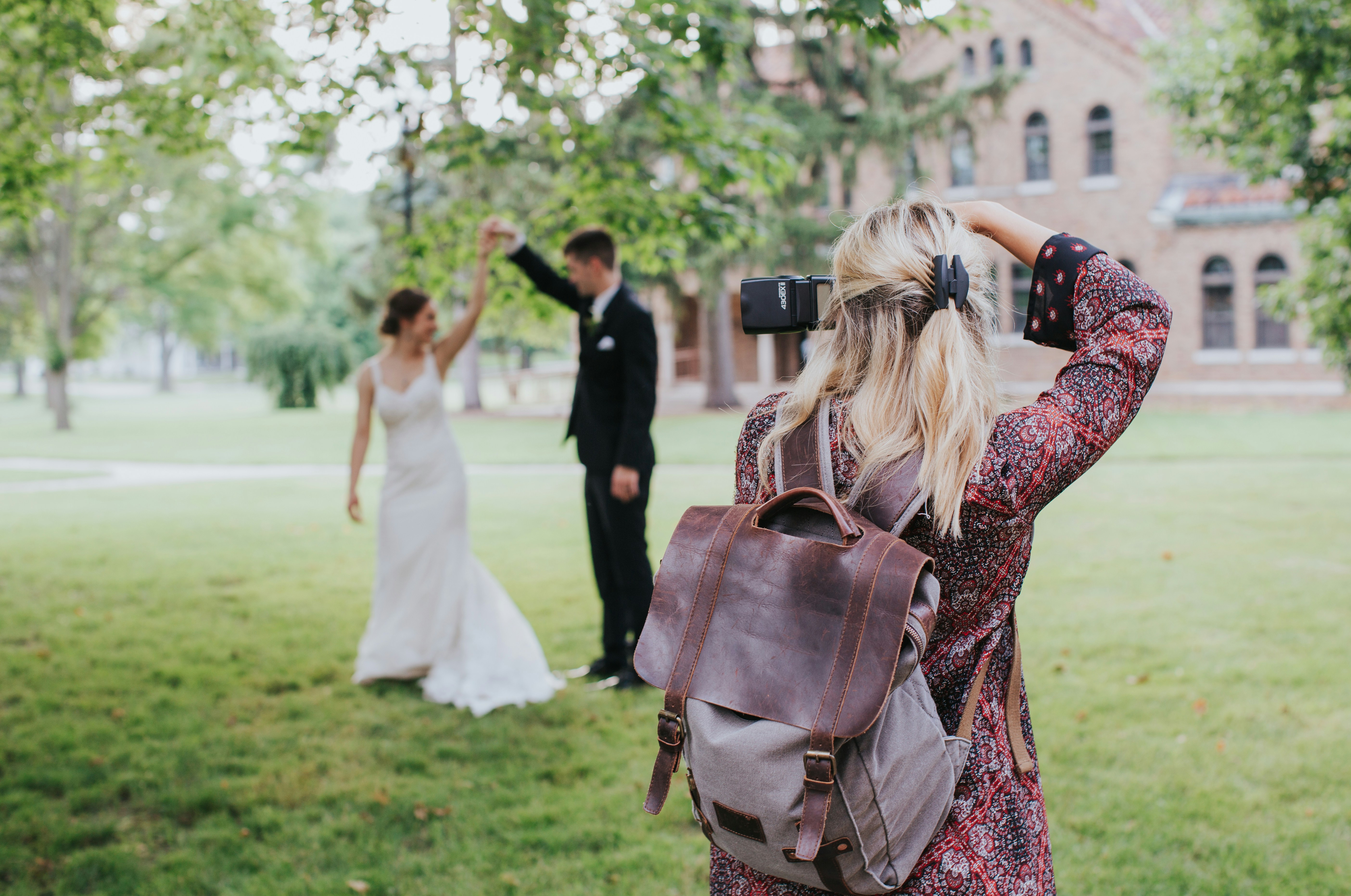 wedding videographer filming a bride and groom spinning