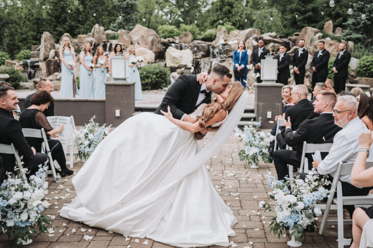Photo of a married couple kissing down the aisle taken by Shutter & Sound